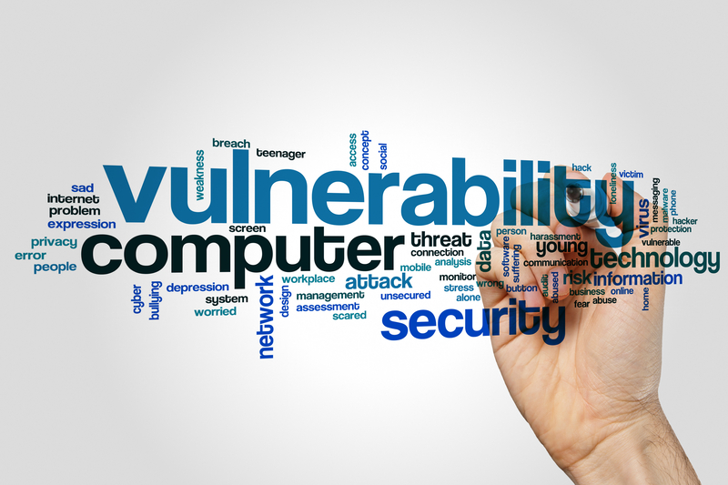 Man's hand writing vulnerability word cloud