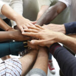 Group of business people joining hands in a circle