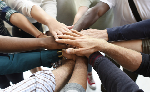 Group of business people joining hands in a circle